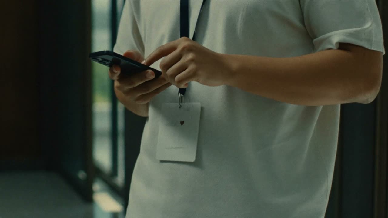 An employee clocking in from their own phone at a client site